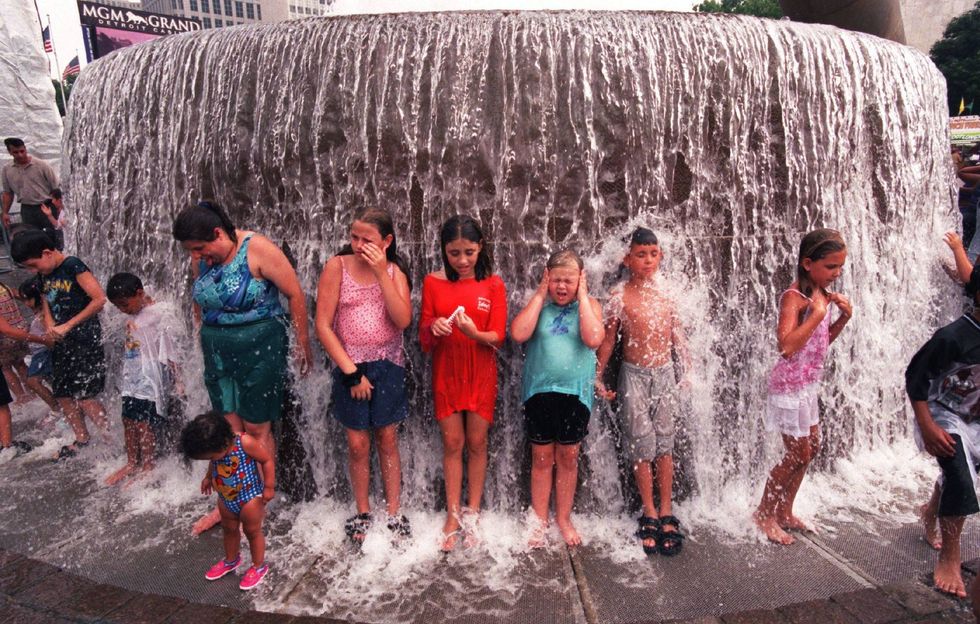 Kids play in the water fountain in Hart Plaza during the Detroit 300 celebration in July 2001