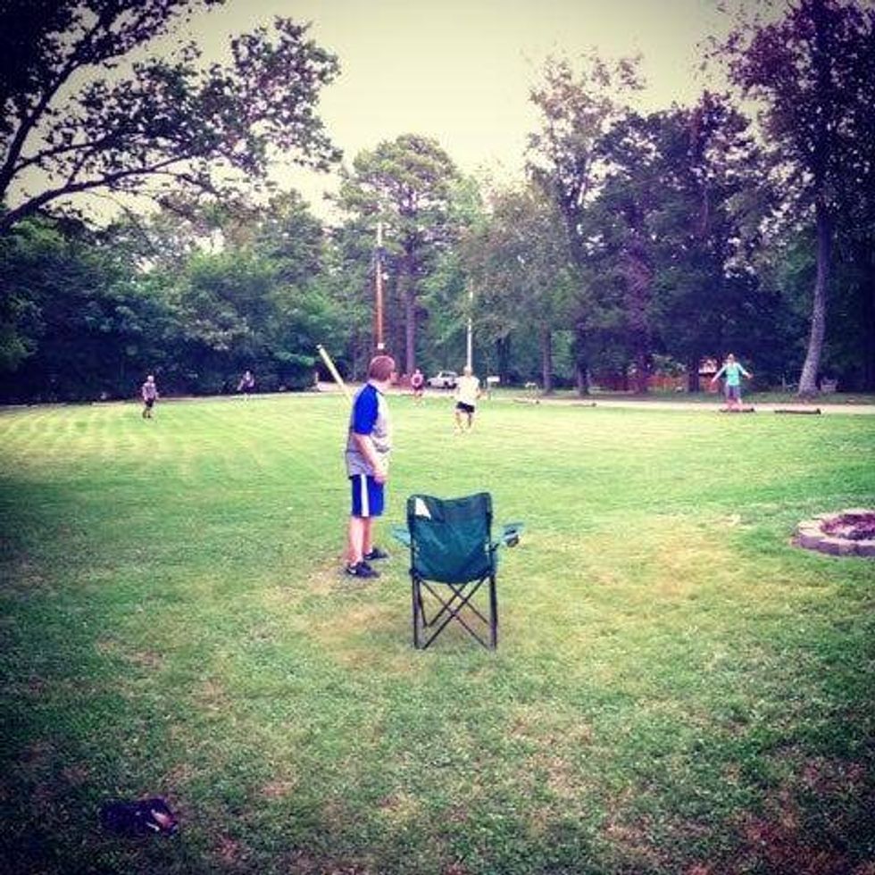 kids playing fuzzball in a field
