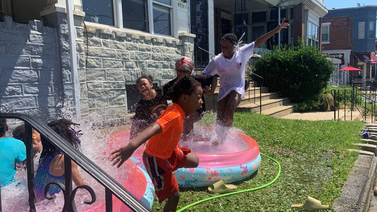 Kids playing in water during Tuesday's near-record heat in Philadelphia.