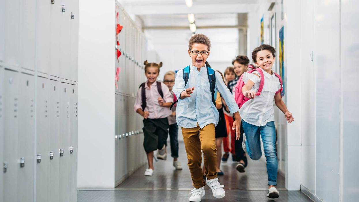 Kids running through school corridor
