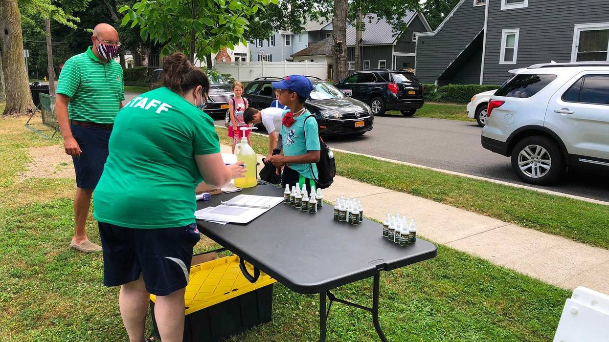 Kids sanitize their hands and undergo a temperature check before beginning summer youth camp in the Village of Hamburg. July 6, 2020 (WBEN Photo/Mike Baggerman)