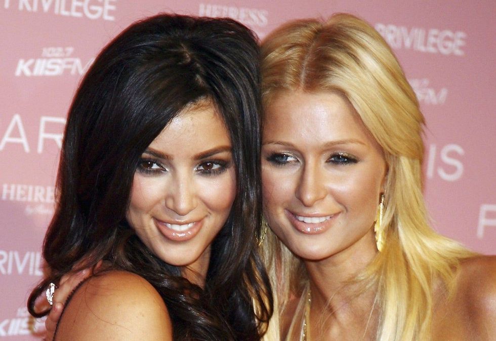 Kim Kardashian and Paris Hilton ride sled together during extravagant Christmas party