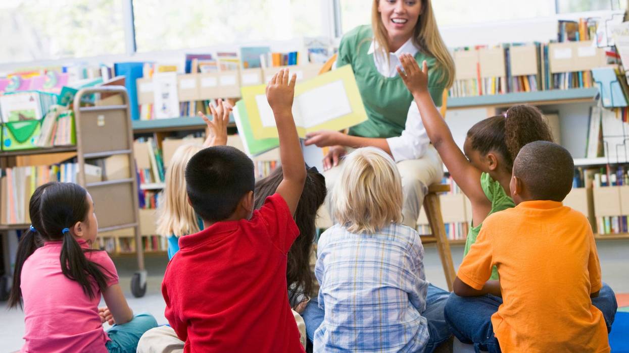 Kindergarten teacher reading to children