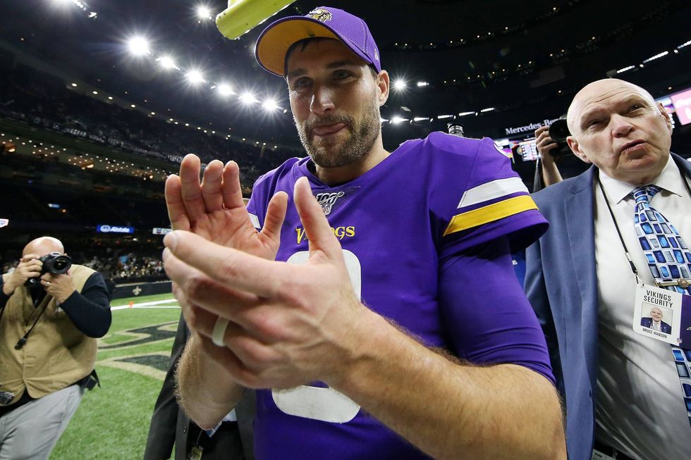 Kirk Cousins celebrates after a playoff victory over the Saints