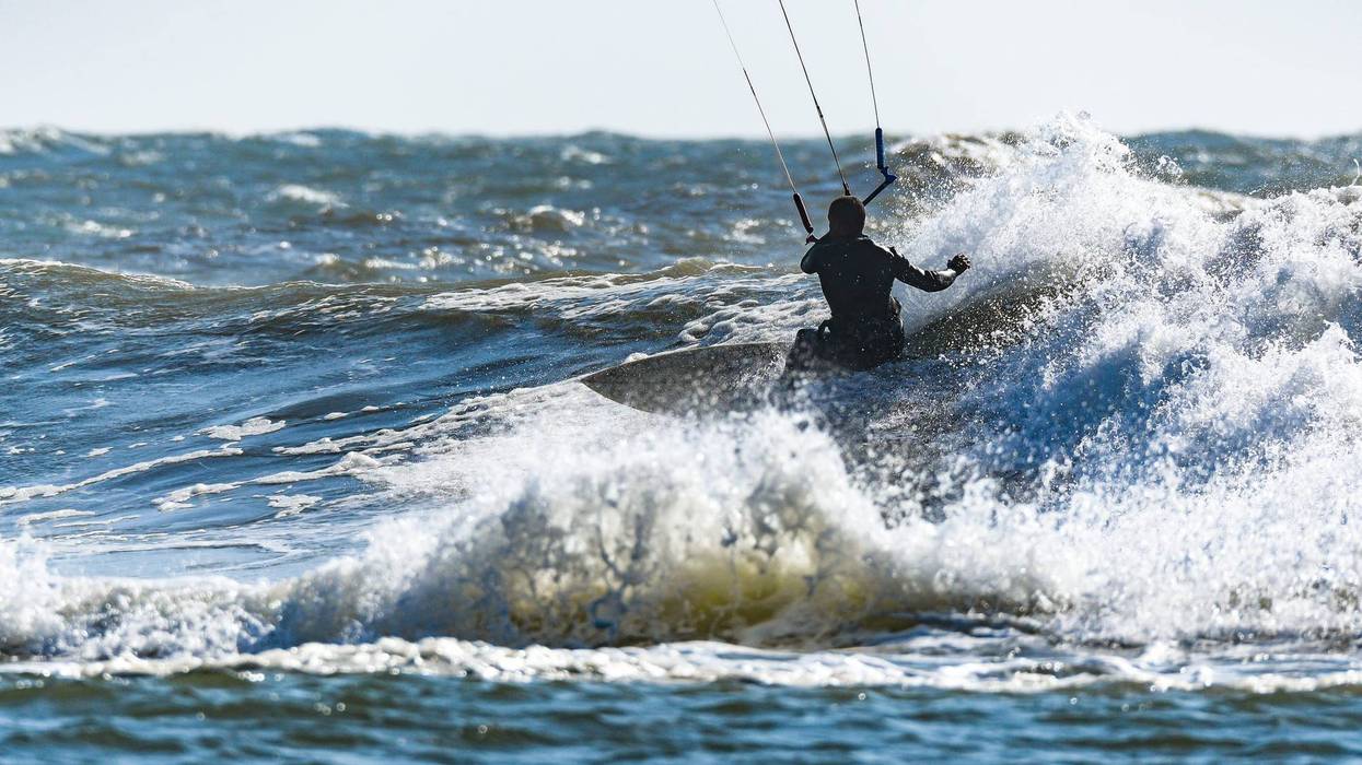 Kitesurfer riding ocean waves