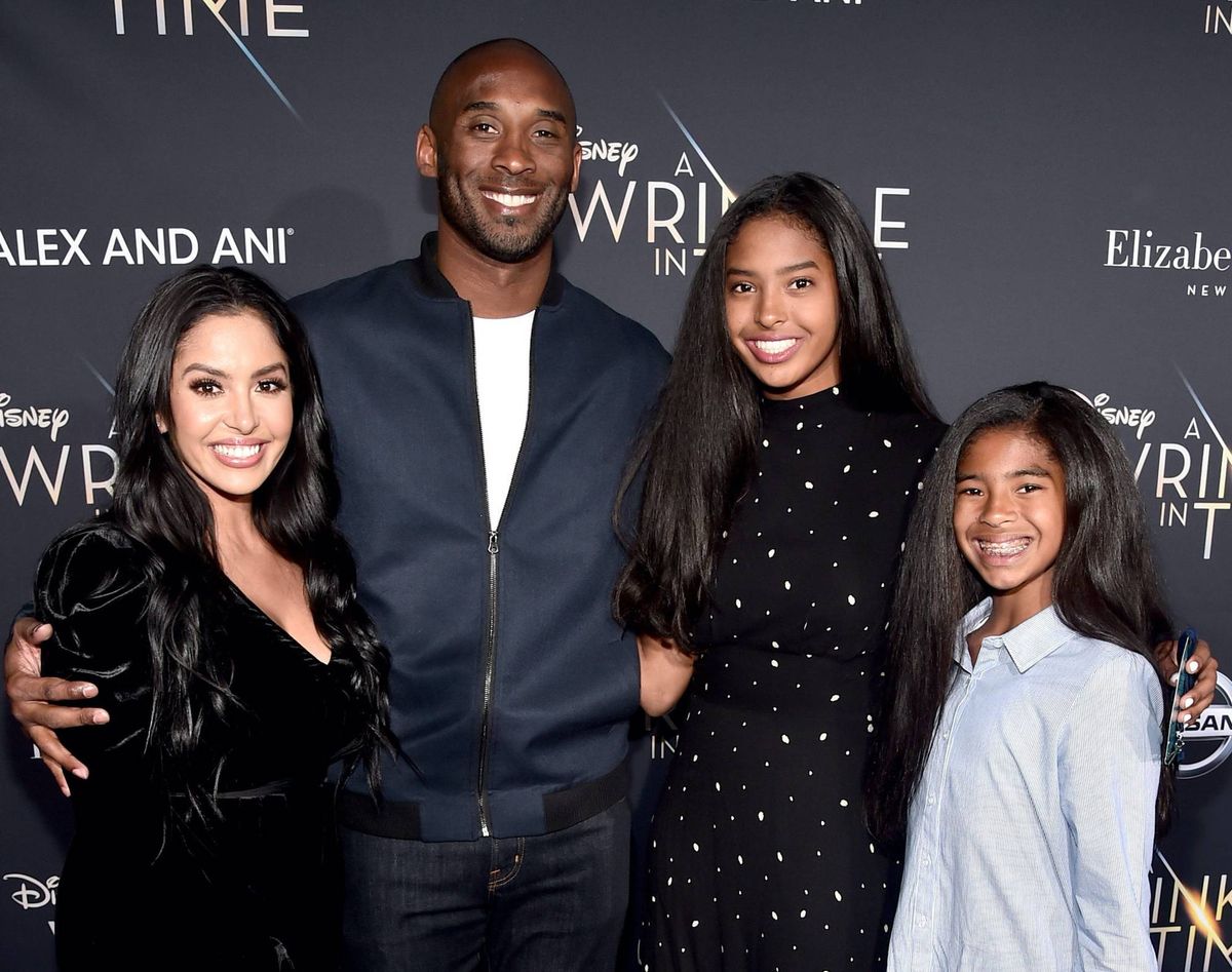 Kobe Bryant smiling with is wife Vanessa, and daughters, Natalia and Gianna