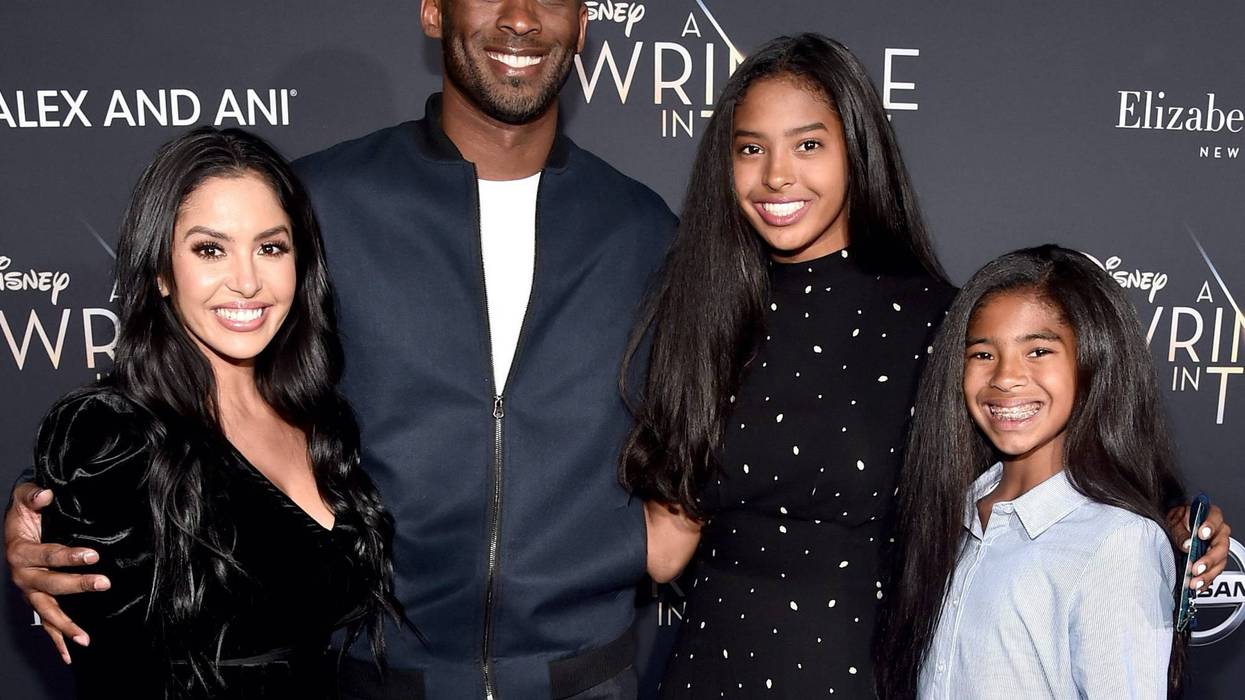 Kobe Bryant smiling with is wife Vanessa, and daughters, Natalia and Gianna