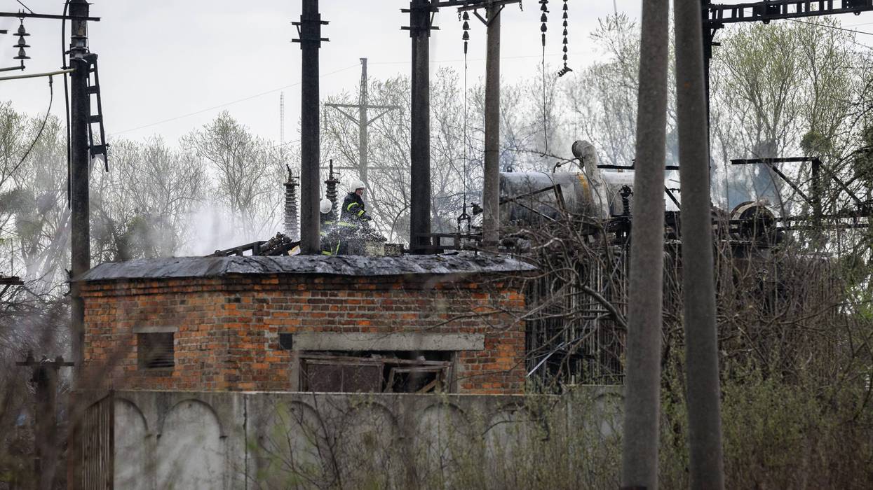 KRASNE, UKRAINE - APRIL 25: A firefighter surveys the damage at traction substation building near rail lines, which officials said were the target of a Russian missile attack, on April 25, 2022 near Lviv, Ukraine. The head of Ukrainian Railways said in a social media post today that five rail facilities had been attacked by Russia this morning, including a "traction substation," a facility supplying power to overhead lines, in Krasne, near Lviv.