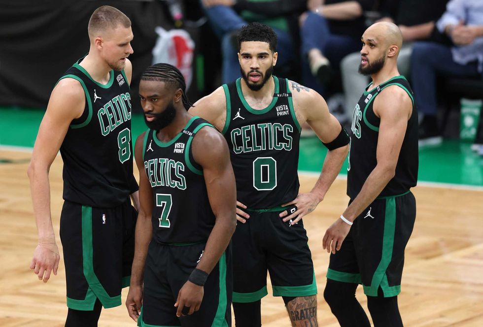 Kristaps Porzingis #8, Jaylen Brown #7, Jayson Tatum #0, and Derrick White #9 of the Boston Celtics look on during the second quarter against the Dallas Mavericks in Game Two of the 2024 NBA Finals at TD Garden on June 09, 2024 in Boston, Massachusetts.