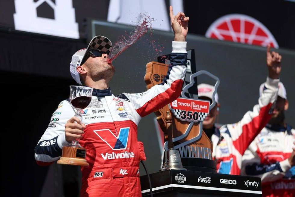 Kyle Larson, driver of the #5 Valvoline Chevrolet, celebrates with wine in victory lane after winning the NASCAR Cup Series Toyota/Save Mart 350 at Sonoma Raceway on June 09, 2024 in Sonoma, California.