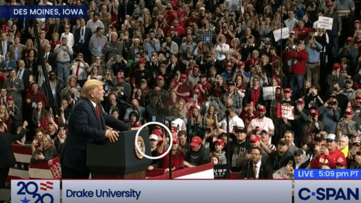 Kyle Rittenhouse (circled) can be seen wearing a white hat in the front row of a Trump rally in Des Moines, Iowa, Jan. 30. (CSPAN)