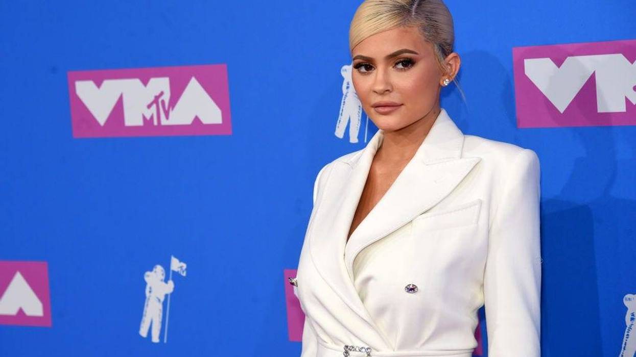 Kylie Jenner Rocks a Revealing Red Bow to Promote Holiday Makeup Line