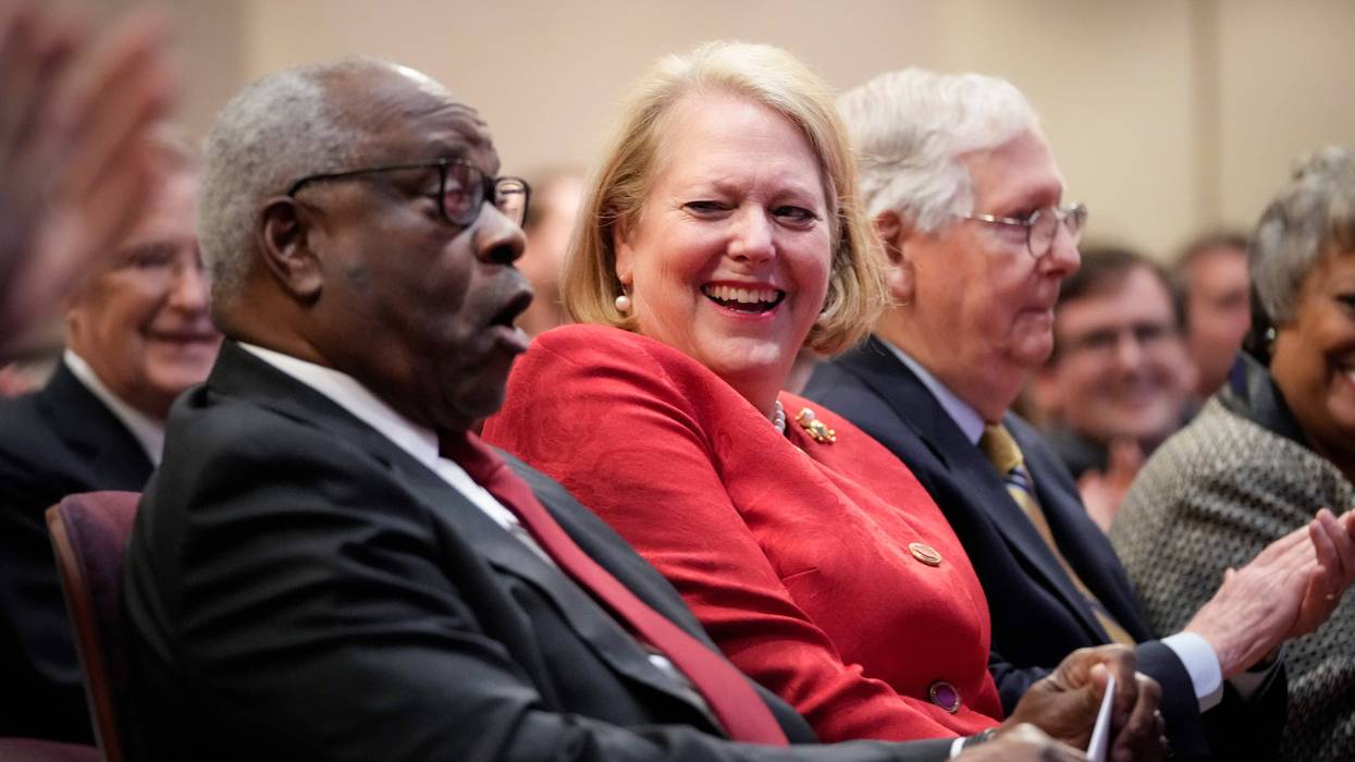 (L-R) Associate Supreme Court Justice Clarence Thomas sits with his wife and conservative activist Virginia Thomas.