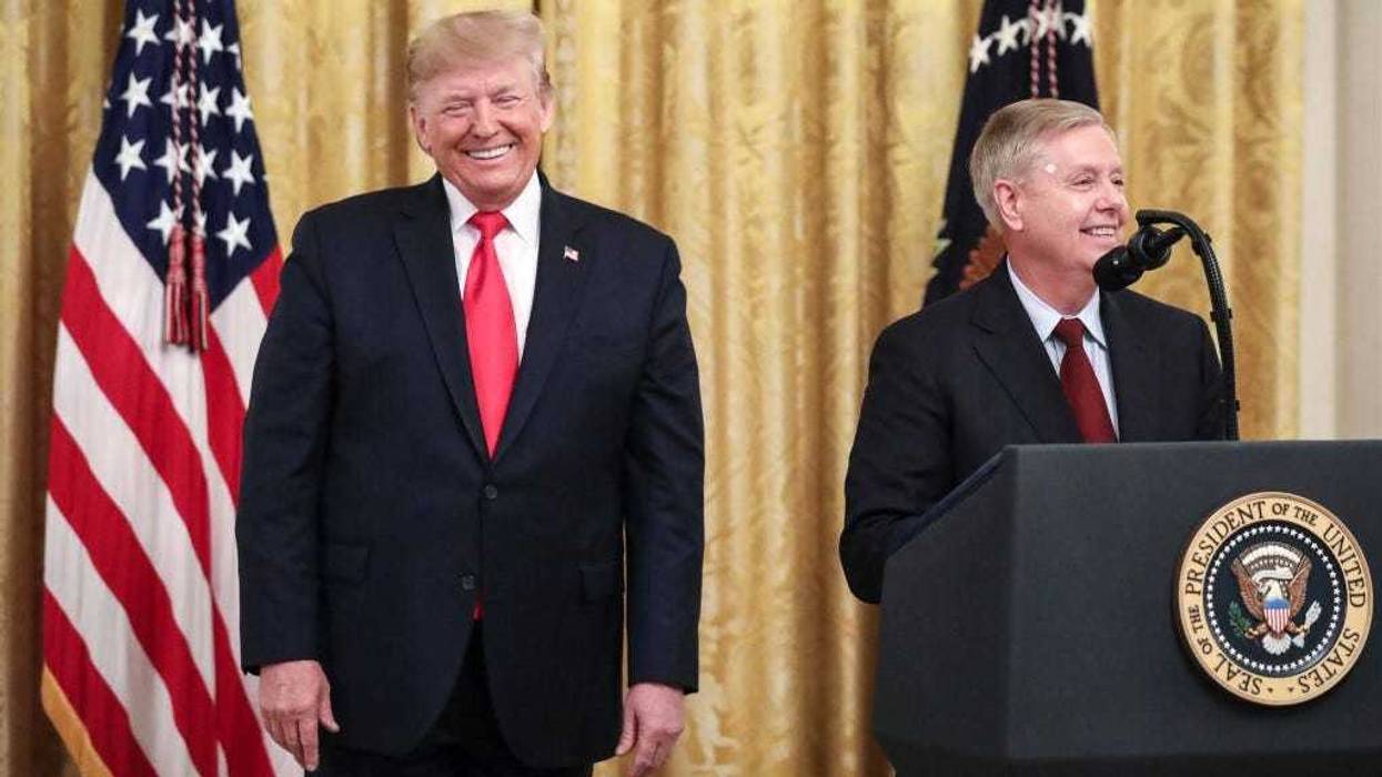 (L-R) President Donald Trump looks on as Sen. Lindsey Graham (R-SC) speaks during an event about judicial confirmations in the East Room of the White House on November 6, 2019 in Washington, DC.