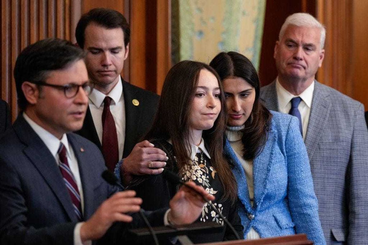 (L-R) U.S. Speaker of the House Mike Johnson (R-LA) speaks as Bella Ingber, a college student from New York University, and Talia Khan, a college student from Massachusetts Institute of Technology, embrace during a news conference at the U.S. Capitol December 5, 2023 in Washington, DC. House Republicans were joined by Jewish college students who described their recent experiences with antisemitism on their campuses. (Photo by Drew Angerer/Getty Images)