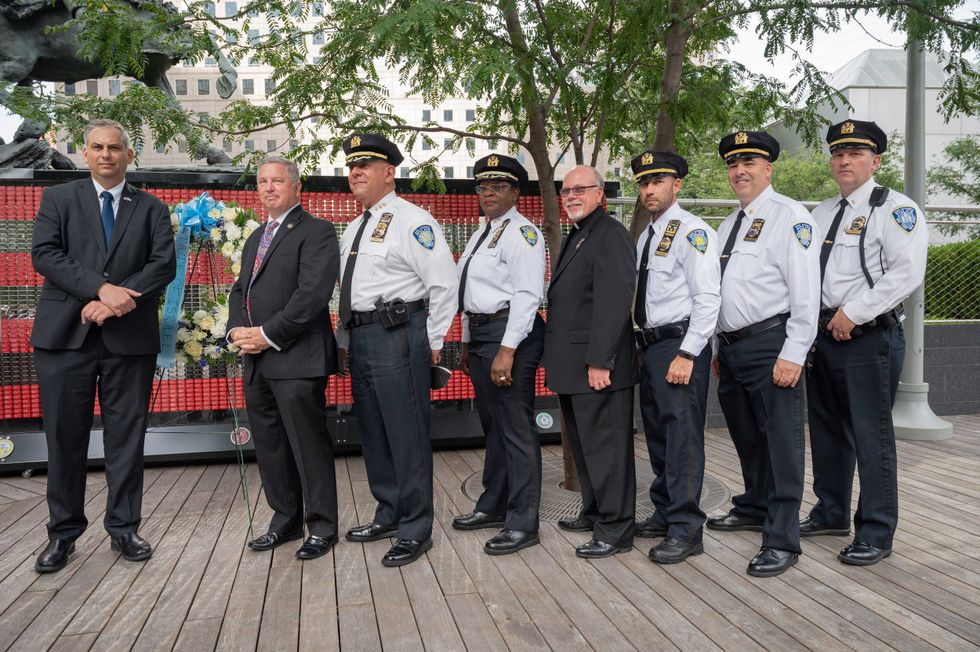 (L to R) Acting Consul General of Israel in New York Israel Nitzan, Port Authority Police Superintendent Ed Cetnar, Chief of Department Emilio Gonzalez; Deputy Chief Gloria Frank, Chief Deacon George Albin, Lt. Scot Pomerantz, Inspector Steve Yablonsky and Lt. Thomas Michaels at the VAU Fallen Heroes Memorial in Ground Zero on August 31, 2021 in New York City.