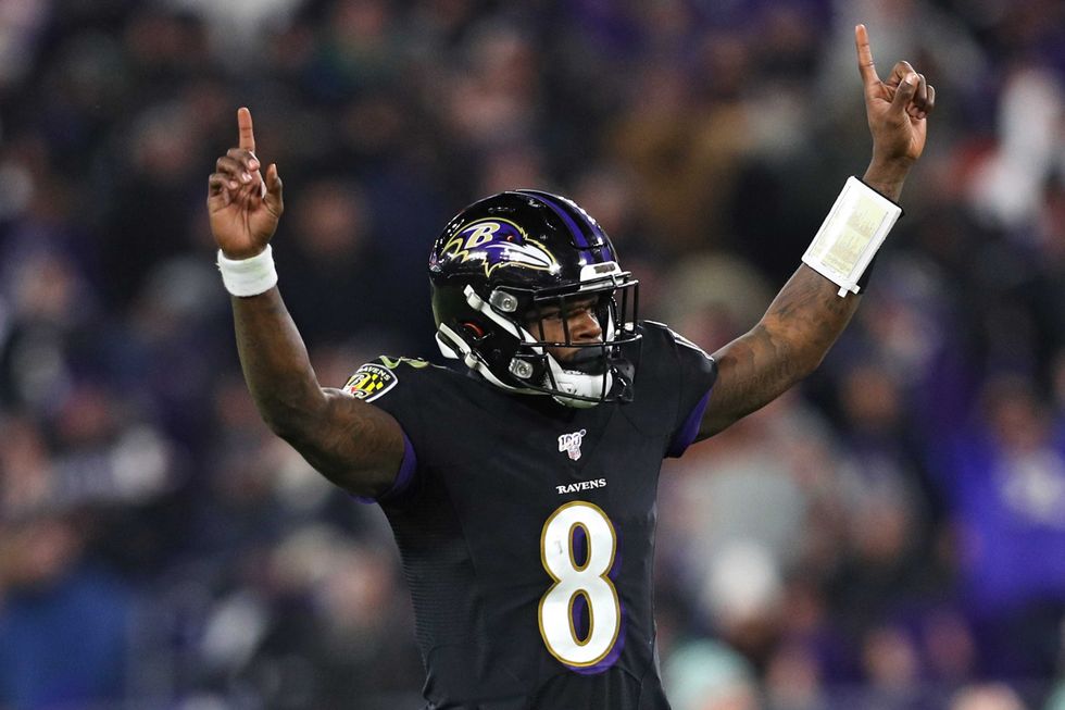 Lamar Jackson admires one of his league-best 36 touchdown throws in 2019
