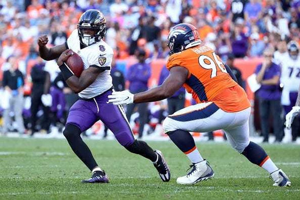 Lamar Jackson evades a tackler