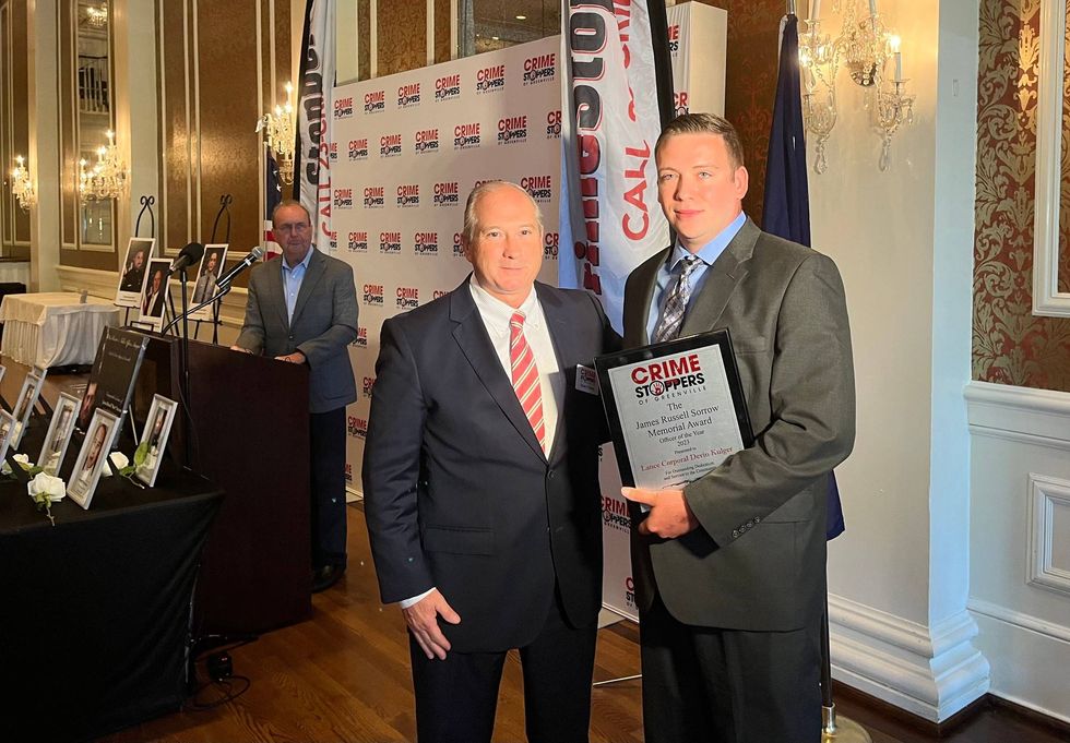 Lance Corporal Devin Kugler receiving the James Russel Sorrow Memorial Award from Crime Stoppers of Greenville Vice President Chuck Thomas