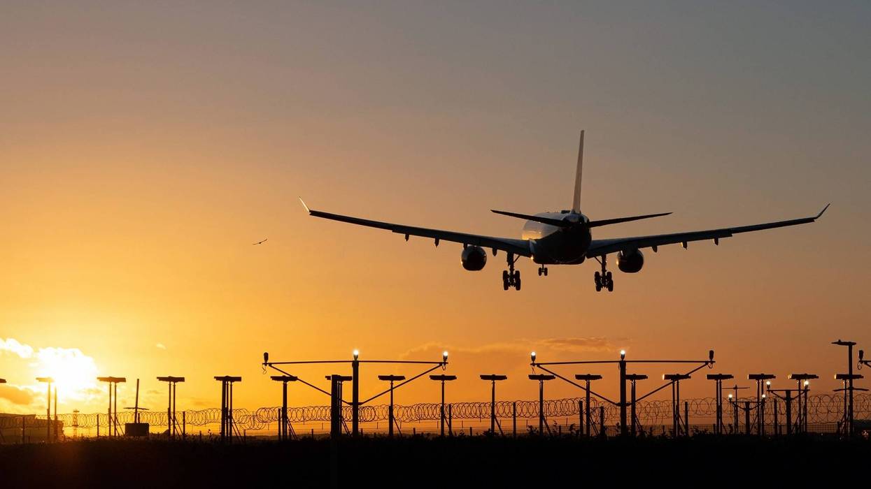 Landing passenger plane during sunset.