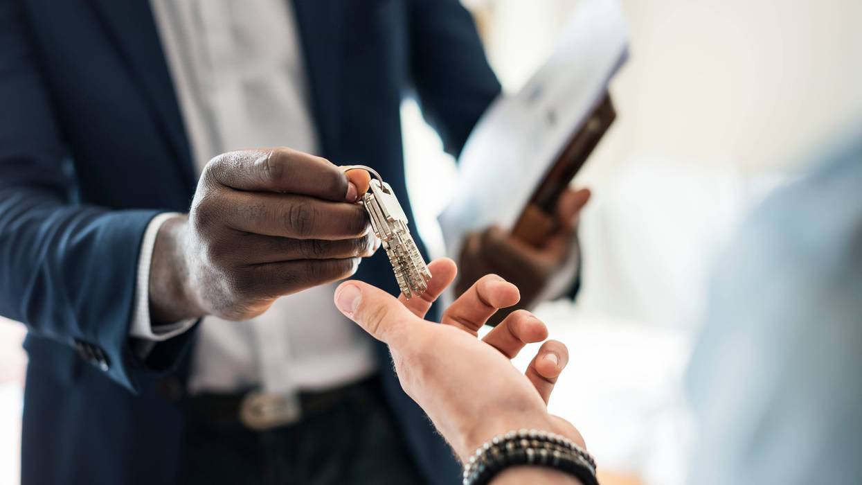 Landlord hands keys to a tenant.