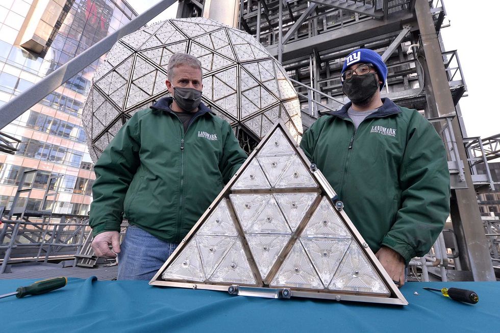 Landmark electricians Chris Sisti and Nick Bonavita demonstrate the installation of one of 192 Waterford crystals into a panel that will be placed on the Times Square New Year