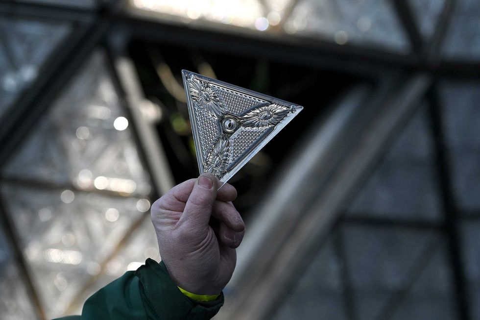 Landmark electricians Chris Sisti holds up one of 192 Waterford crystals triangles that will be placed onto a panel that will be added to the Times Square New Year