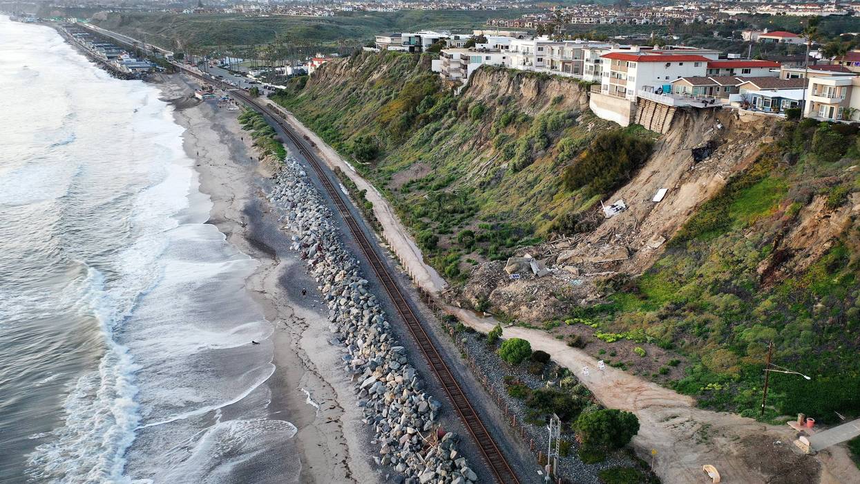 landslide down hill by railroad tracks