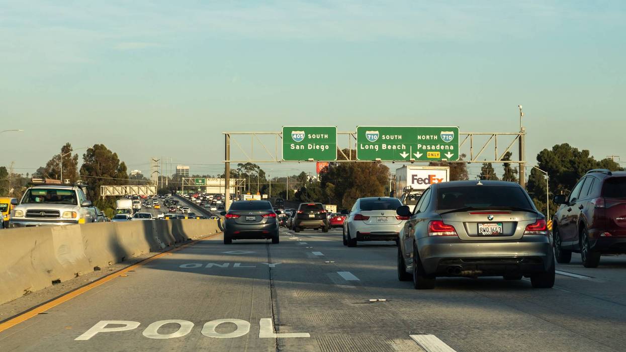 lanes of traffic underneath freeway signage