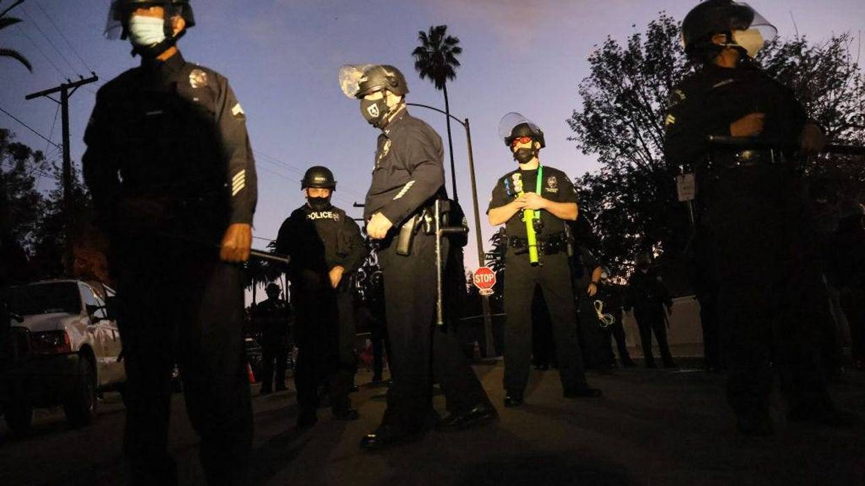 LAPD officers block the street near Echo Park Lake as protesters demonstrate nearby against the removal of a homeless encampment on March 25, 2021 in Los Angeles, California. The park was fenced off following the protests.