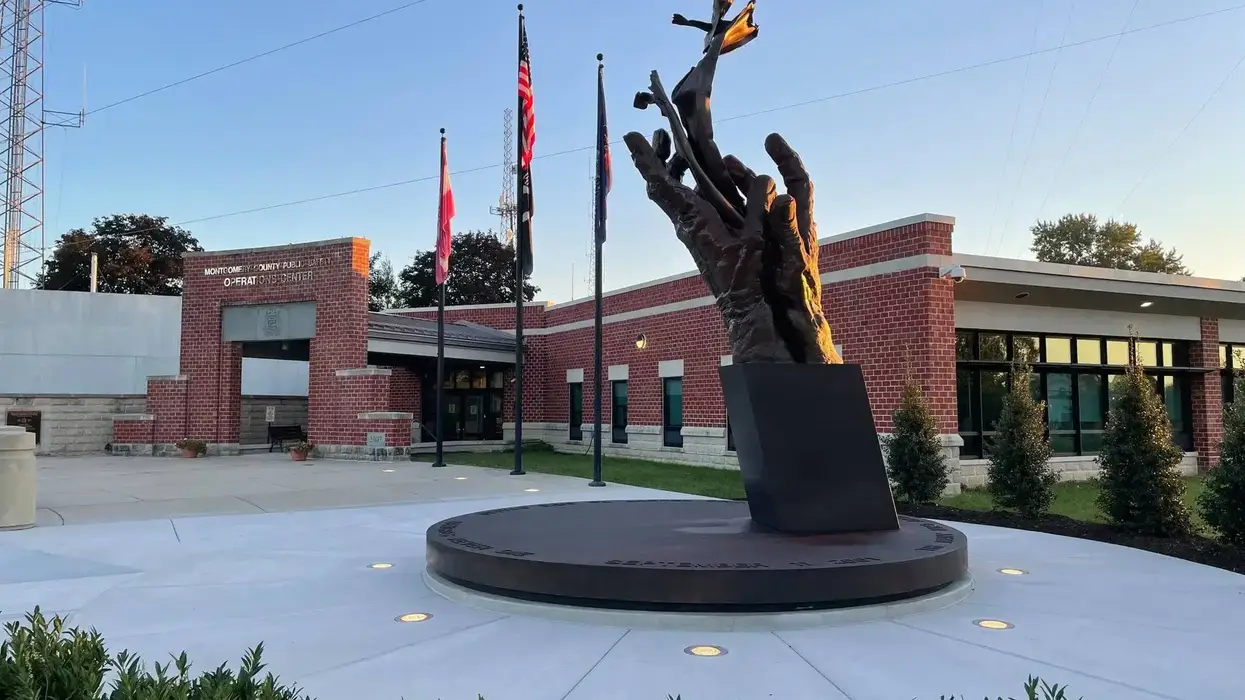 Large bronze sculpture of hands releasing birds at Montgomery County Public Safety Operations Center.