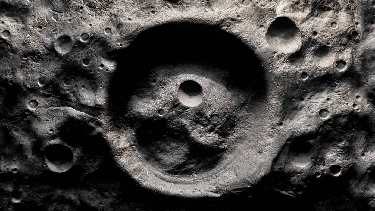 Large crater on the surface of the satellite. Traces of collisions.