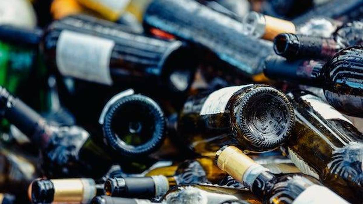 Large pile of empty wine bottles