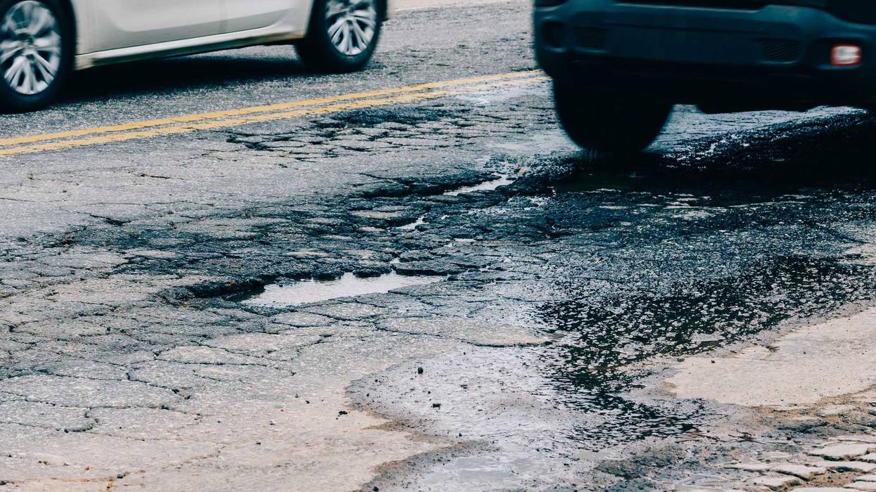 Large pothole in the middle of the road.