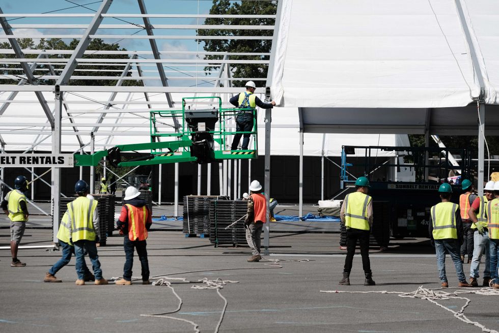 Large tents are constructed in a parking lot at Orchard Beach in the Bronx on Sept. 28, 2022
