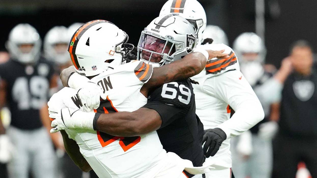 Las Vegas Raiders defensive tackle Adam Butler (69) tackles Cleveland Browns quarterback Deshaun Watson (4) during the first quarter at Allegiant Stadium.