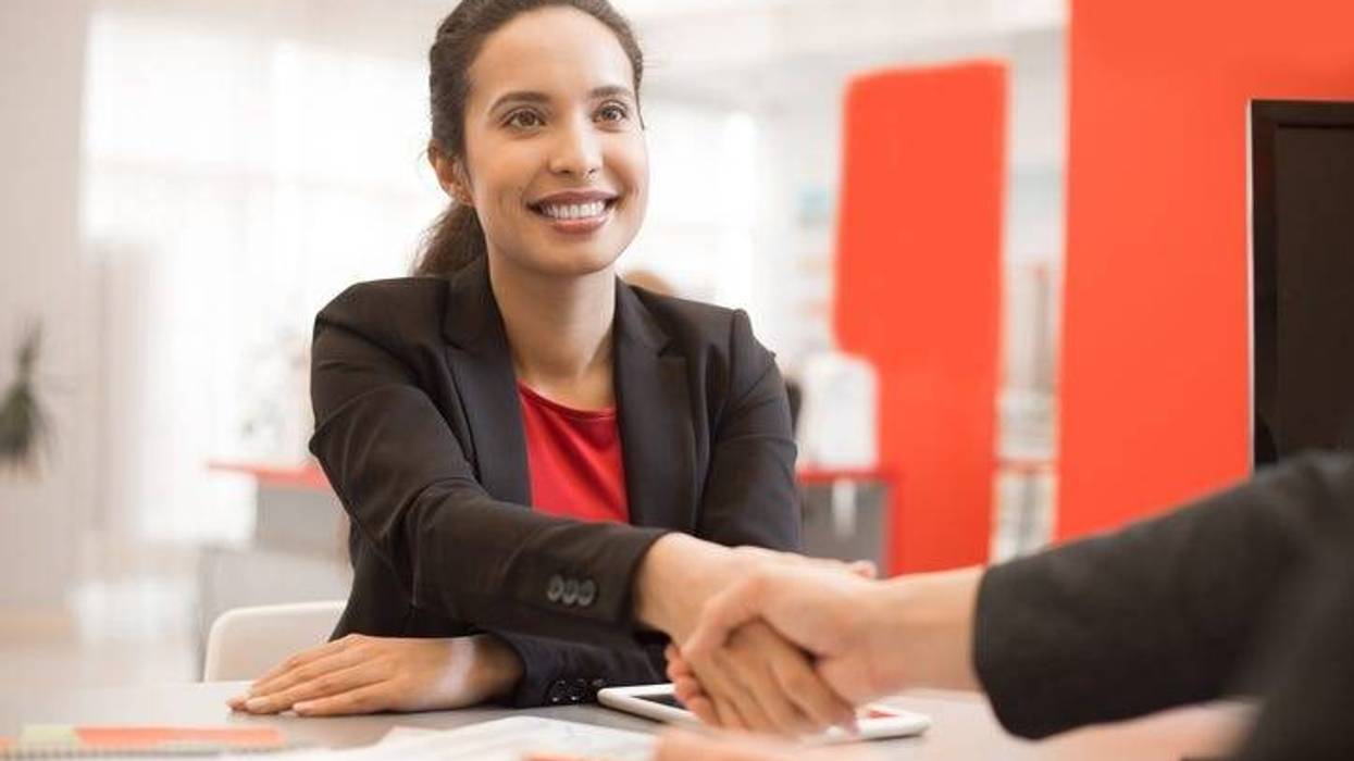 Latin Businesswoman Shaking Hands with Partner