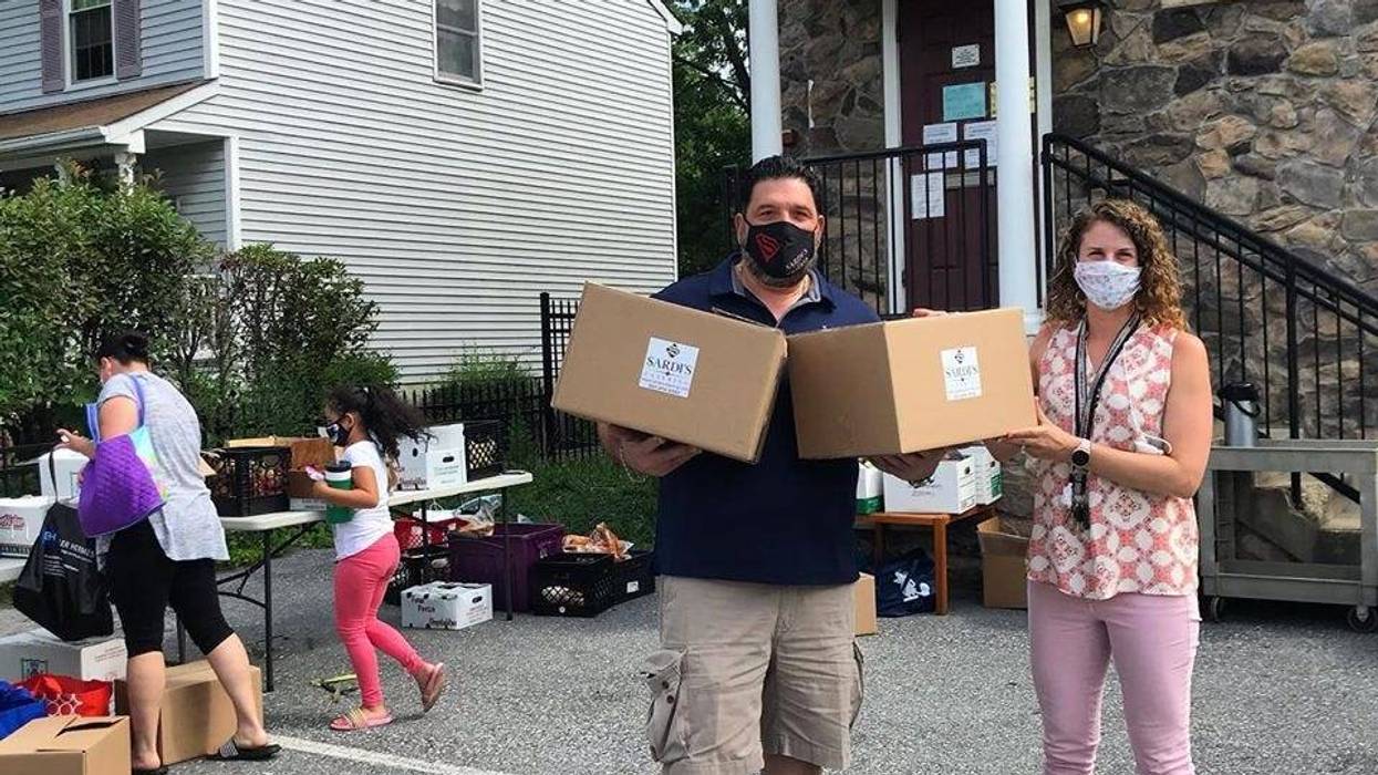 Laurel Advocacy & Referral Services Executive Director Leah Paley with a Sardis Restaurant worker who helped distribute meals