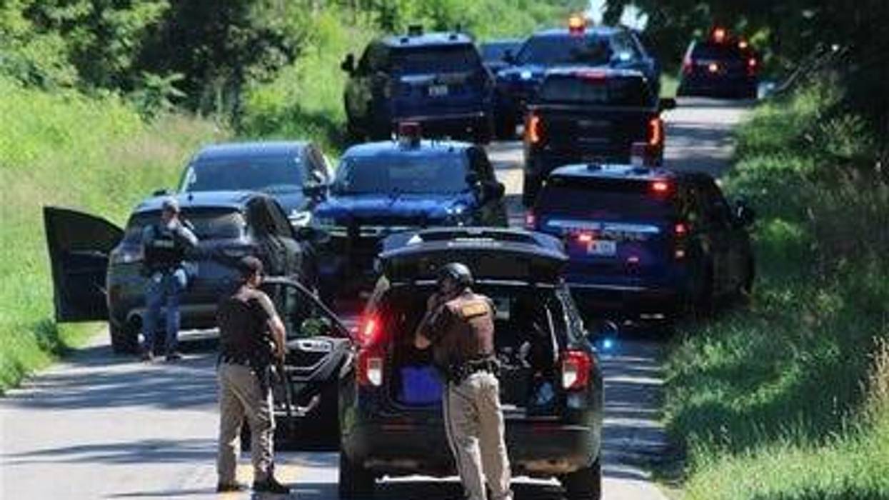 Law enforcement officers are seen actively searching for a suspect who gunned down a Hillsdale County Sheriff's deputy Thursday during a traffic stop.