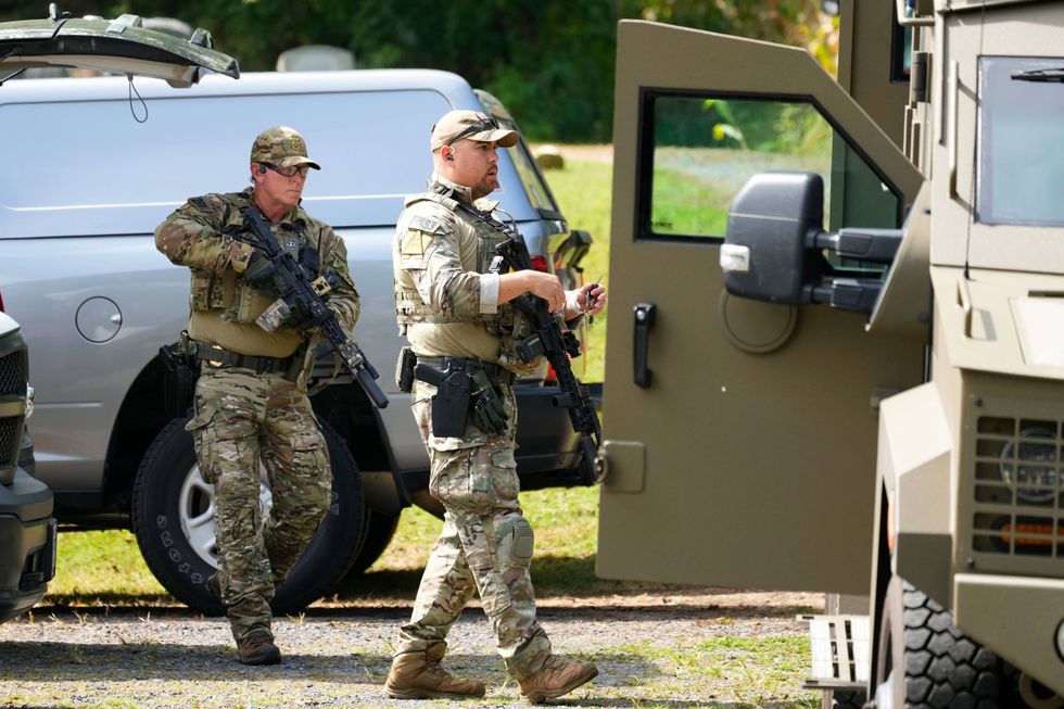 Law enforcement officers gather as they search for escaped convict Danelo Cavalcante in Glenmoore, Pa., Monday, Sept. 11, 2023.