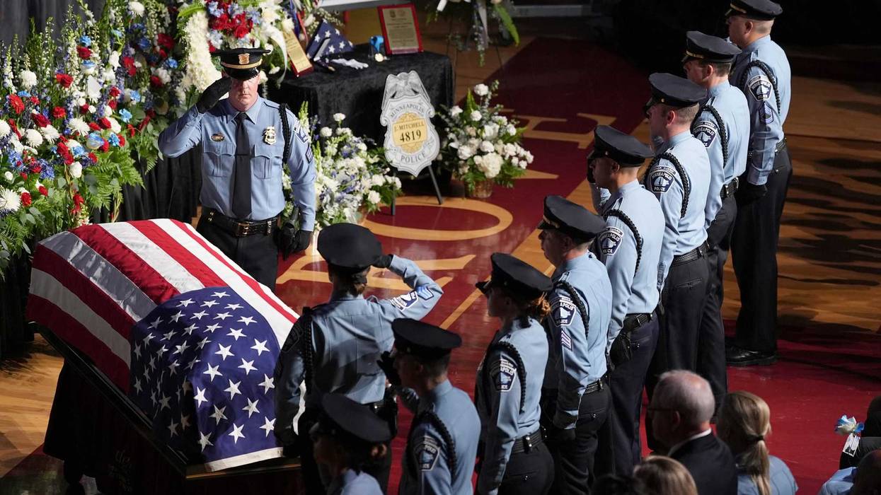 Law enforcement officers salute during a public memorial service for Minneapolis police Officer Jamal Mitchell who was shot and killed while responding to a shooting on May 30, 2024.