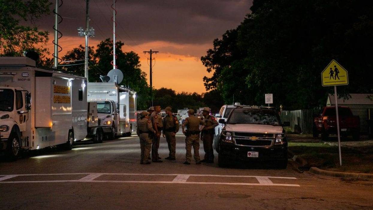 Law enforcement officers speak together outside of Robb Elementary School following the mass shooting at Robb Elementary School on May 24, 2022, in Uvalde, Texas. According to reports, 19 students and 2 adults were killed, with the gunman fatally shot by law enforcement.