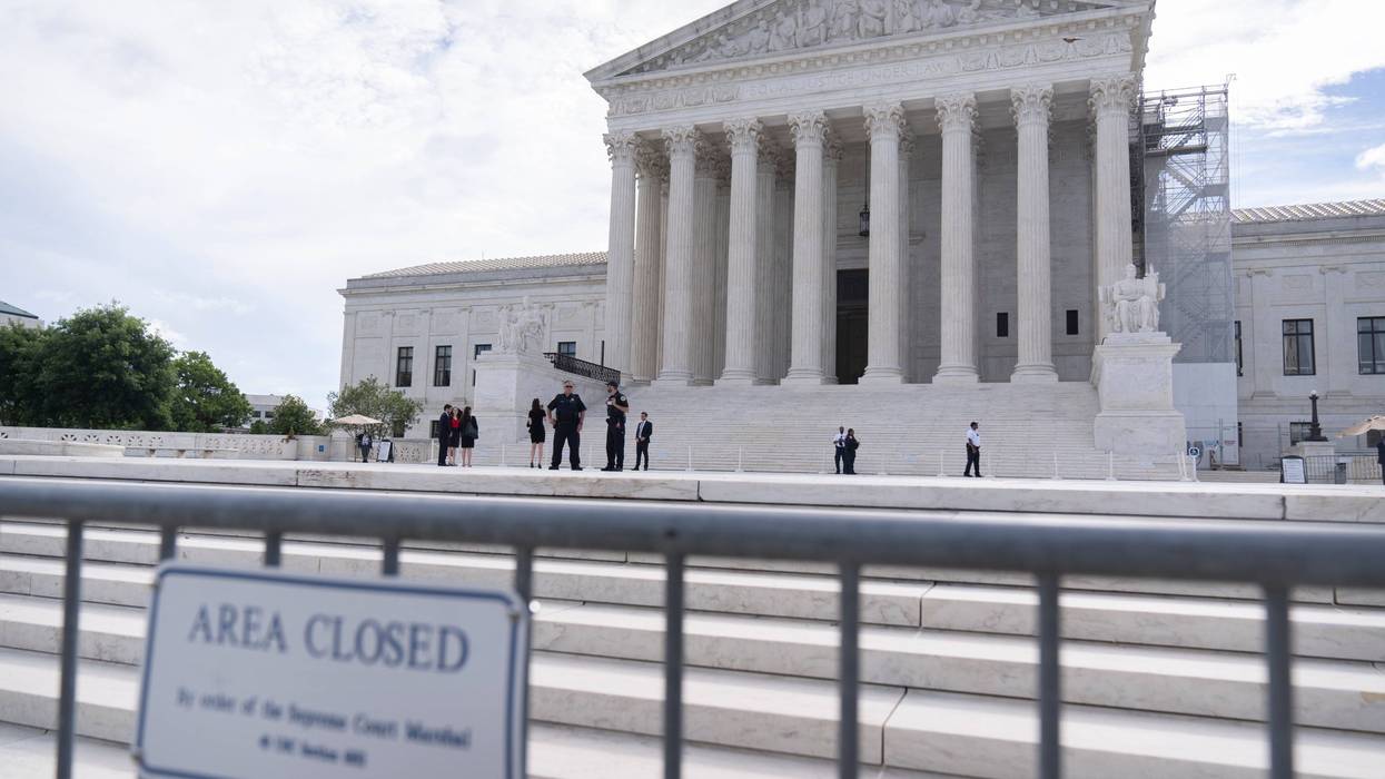 Law enforcement officers stand behind barricades outside the Supreme Court on Thursday, June 27, 2024, in Washington.