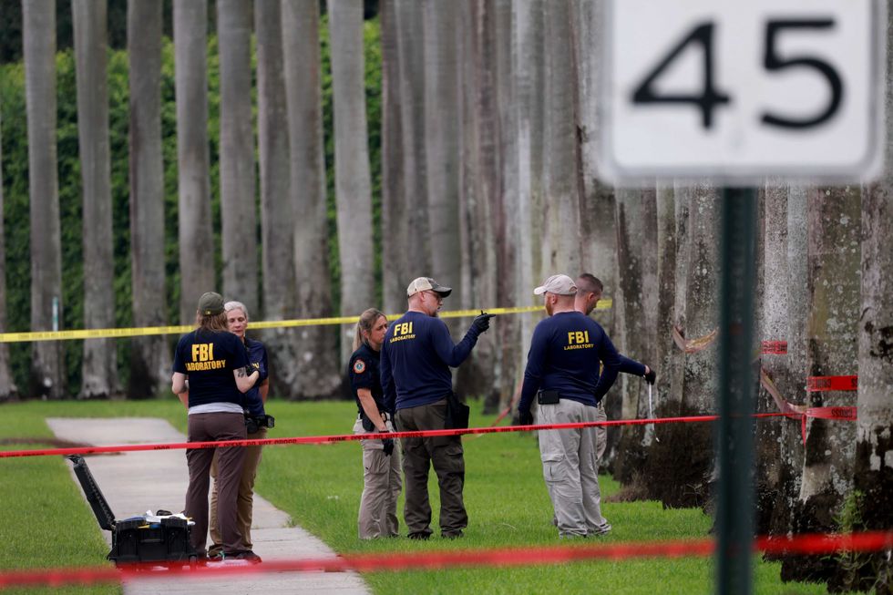 Law enforcement personnel continue to investigate on Sept. 17, 2024, in the area where the Secret Service discovered a man with a gun at the Trump International Golf Club in West Palm Beach