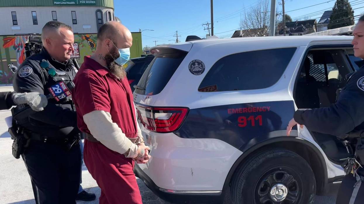 Law enforcement personnel escort Charles Fulforth