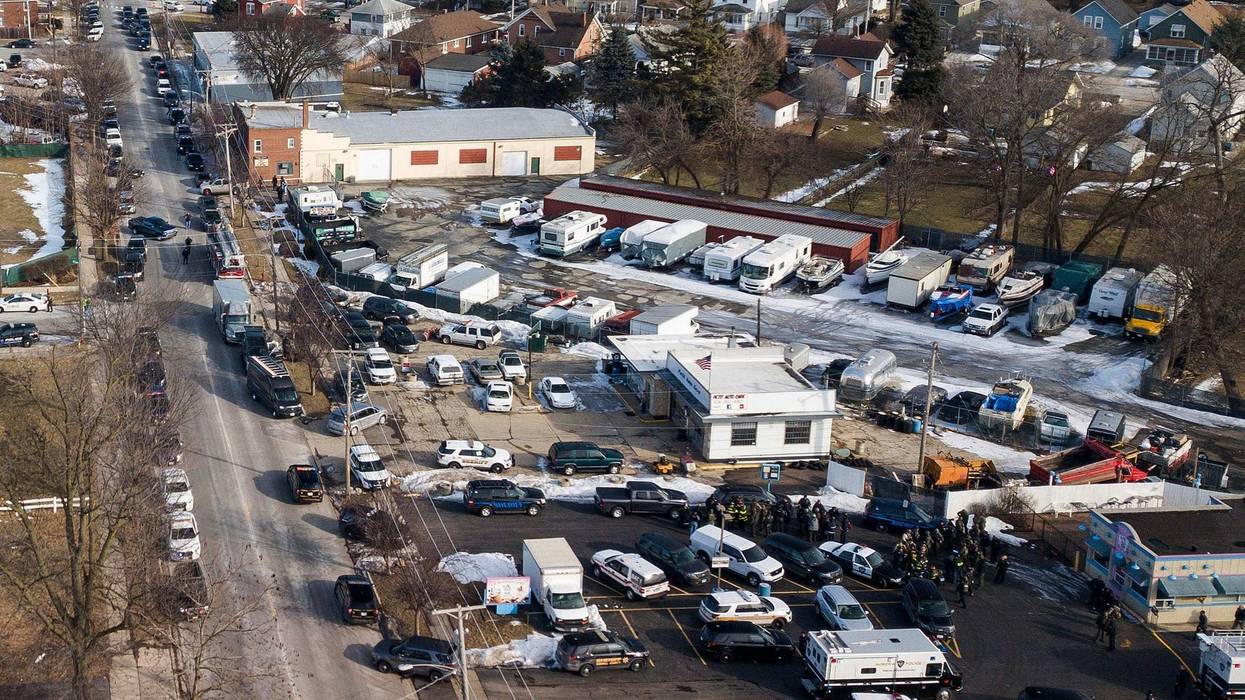 Law enforcement personnel gather near the scene of a shooting at an industrial park in Aurora, Ill., on Friday, Feb. 15, 2019.