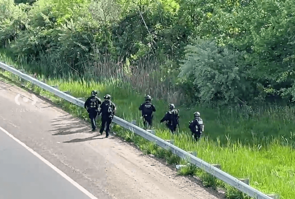 Law enforcement was seen searching the woods along the expressway