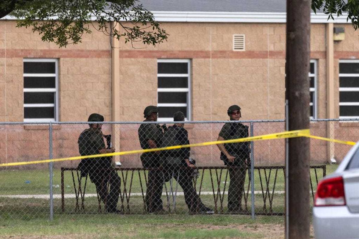 Law enforcement work the scene after a mass shooting at Robb Elementary School in Uvalde, Texas.
