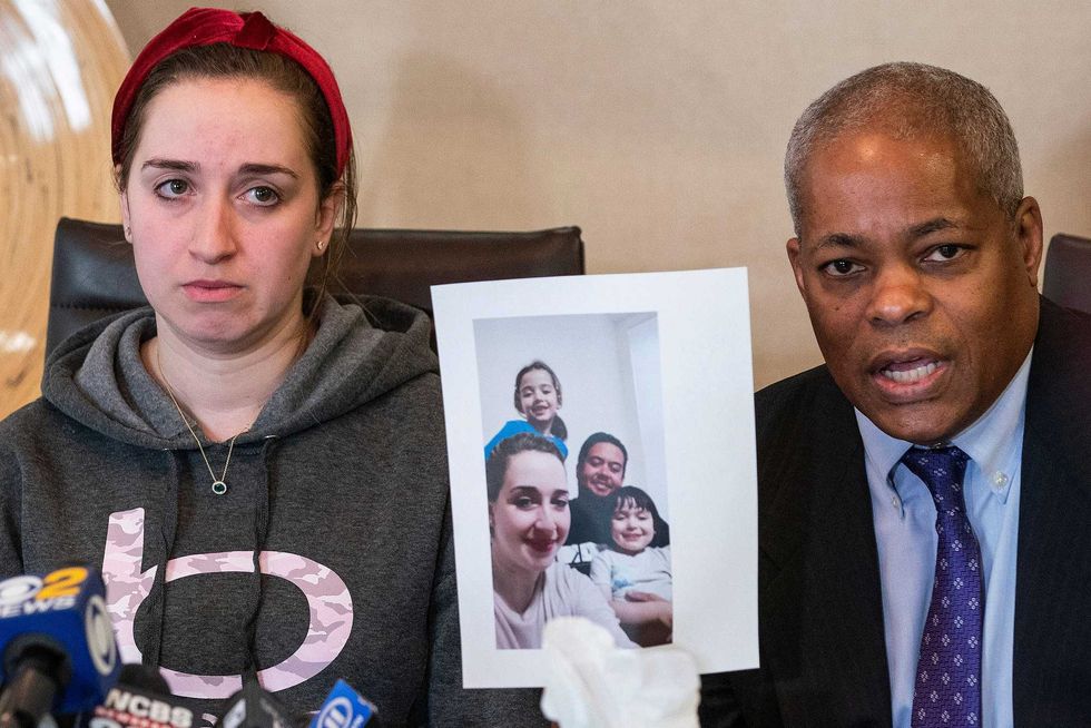 Lawyer Derek Sells holds a picture next to Nadjet Tchenar, the wife of Mohammed Zakaria Salah Rakchi, one of the victims of the U-Haul rampage, as they speak to the media during a press conference on Tuesday, Feb. 14, 2023, in New York