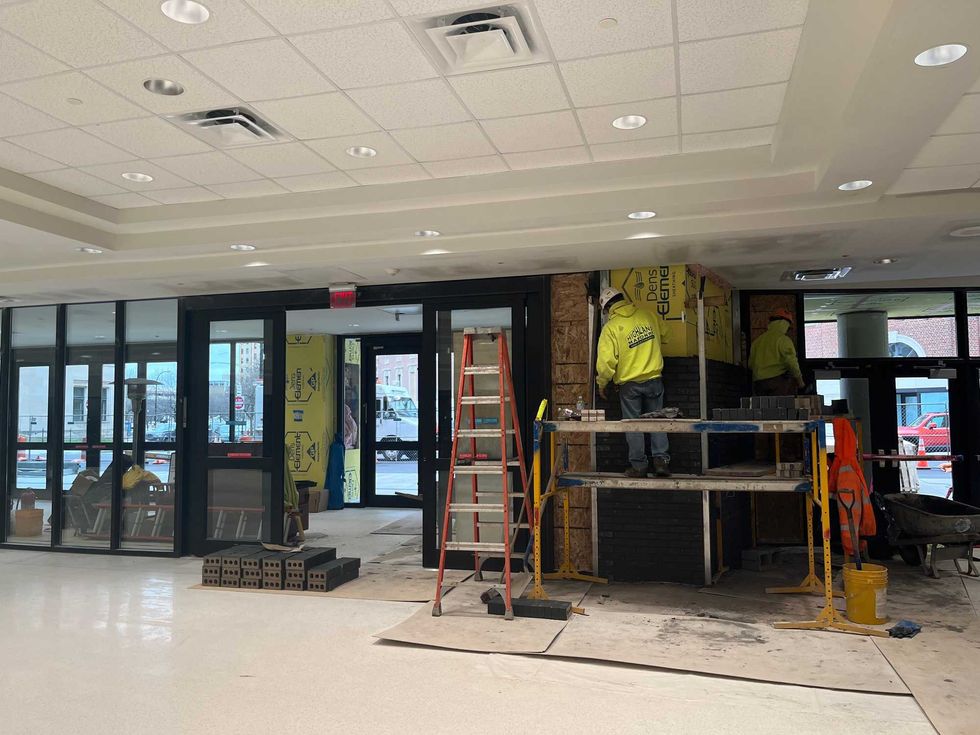 Laying down new black brick near the new entrance of the Buffalo Niagara Convention Center. 12/1/2020 Buffalo, N.Y.